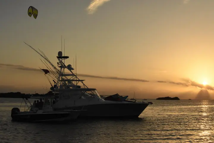 Boat on water at sunset