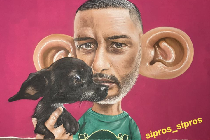 a man and a dog looking at the camera