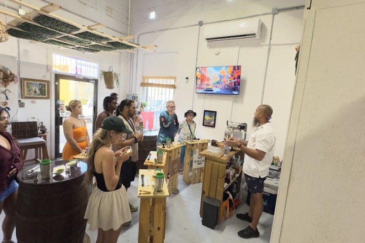 Group of people in a room listening to a man giving a presentation.